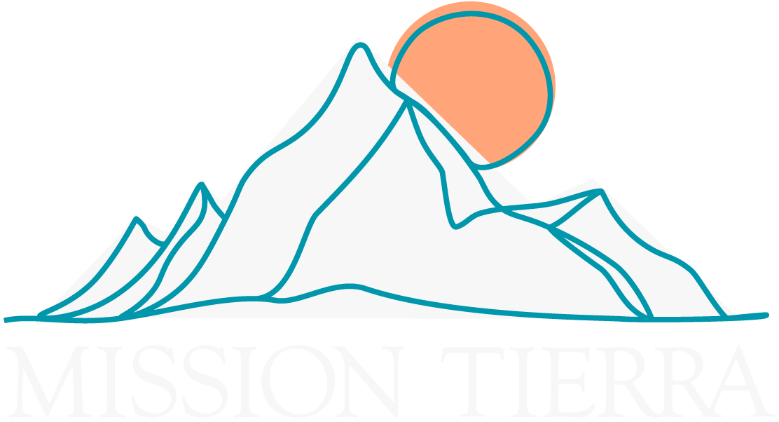 A mountain with a sun and the words "Mission Tierra" below it.